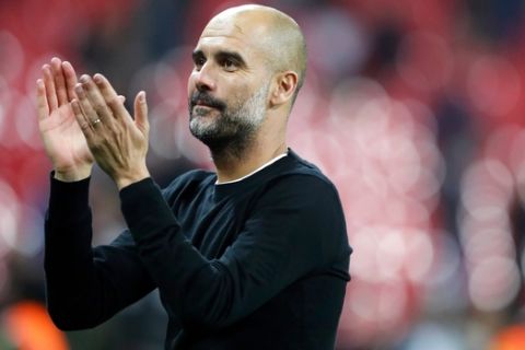 FILE - In this file photo dated Saturday, April 14, 2018, Manchester City manager Pep Guardiola applauds the fans as he walks from the pitch after the end of the English Premier League soccer match against Tottenham Hotspur at Wembley stadium in London.  Guardiola said Friday April 20, 2018, that he will speak with the club at the end of the season about extending his contract at the new Premier League champions.(AP Photo/Frank Augstein, FILE)