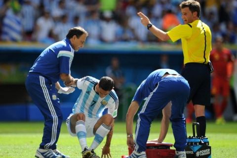 BRASILIA, BRAZIL - JULY 05: Angel Di Maria of Argentina receives treatment during the 2014 FIFA World Cup Brazil Quarter Final match between Argentina and Belgium at Estadio Nacional on July 05, 2014 in Brasilia, Brazil.  (Photo by Chris Brunskill Ltd/Getty Images)