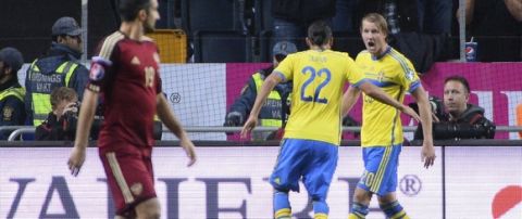Sweden's forward Ola Toivonen (R) celebrates with his teammate midfielder Erkan Zengin after scoring past Russia's goalkeeper Igor Akinfeev on October 9, 2014 at Friends Arena in Solna, near Stockholm during the Euro 2016 qualifying football match between Sweden and Russia. AFP PHOTO / JONATHAN NACKSTRAND        (Photo credit should read JONATHAN NACKSTRAND/AFP/Getty Images)
