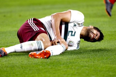 Mexico defender Nestor Araujo (2) suffers a leg injury during the first half of an international friendly soccer match against Croatia in Arlington, Texas, Tuesday, March 27, 2018. (AP Photo/Roger Steinman)