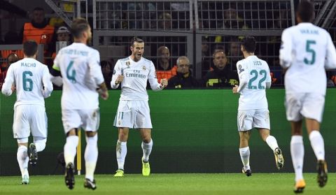 Real Madrid's Gareth Bale, center, celebrates after scoring the opening goal during the Champions League group H soccer match between Borussia Dortmund and Real Madrid CF in Dortmund, Germany, Tuesday, Sept. 26, 2017. (AP Photo/Martin Meissner)