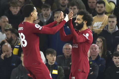 Liverpool's Mohamed Salah, right, celebrates with Liverpool's Cody Gakpo after scoring his side's fourth goal during the English Premier League soccer match between Leeds United and Liverpool at Elland Road in Leeds, England, Monday, April 17, 2023. (AP Photo/Rui Vieira)