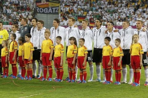 A Germany's team with the young macots listen to national anthem before their Group B Euro 2012 soccer match against Denmark at the New Lviv stadium in Lviv, June 17, 2012.   REUTERS/Thomas Bohlen (UKRAINE  - Tags: SPORT SOCCER)  