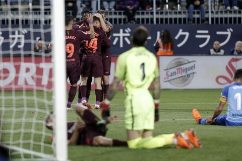 Barcelona's Coutinho celebrates with team mates scoring his side's 2nd goal during a Spanish La Liga soccer match between Malaga and Barcelona in Malaga, Spain, Saturday, March 10, 2018. (AP Photo/M.Pozo)