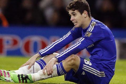 FILE - In this Feb. 3, 2016 file photo, Chelsea's Oscar sits on the pitch during the English Premier League soccer match between Watford and Chelsea at the Vicarage Road stadium in London. The governing body of Chinese soccer plans a series of measures in response to what is termed "irrational" spending by clubs on transfer fees and player salaries, amid concerns that foreign stars are crowding out local talent and harming the country's goal of becoming a global force in the sport. Shanghai Shenhua said it paid an $11 million transfer fee to Argentina's Boca Juniors for Teves. Oscar was purchased from Chelsea, and Brazilians Hulk, Ramires, Alex Teixeira and Paulinho, Colombian striker Jackson Martinez and Argentine forward Ezequiel Lavezzi also joined the league. (AP Photo/Frank Augstein, File)