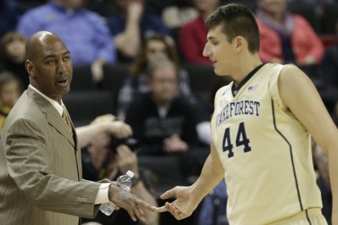 Wake Forest head coach Danny Manning, left, encourages Konstantinos Mitoglou, right, after a missed basket against North Carolina-Asheville during the first half of an NCAA college basketball game in Winston-Salem, N.C., Friday, Nov. 14, 2014. (AP Photo/Chuck Burton)