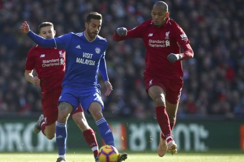 Cardiff City's Victor Camarasa, second left  and Liverpool's Fabinho battle for the ball during the English Premier League soccer match between Liverpool and Cardiff City at Anfield, in Liverpool, England, Saturday, Oct. 27, 2018. (Dave Thompson/PA via AP)