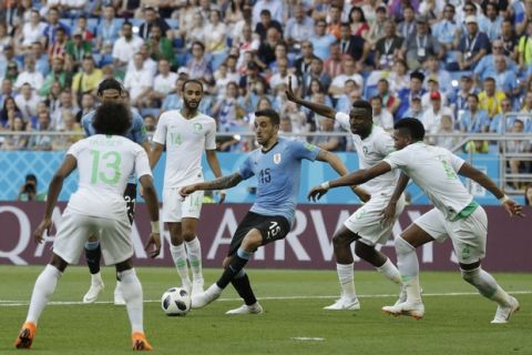 Uruguay's Matias Vecino is surrounded by Saudi Arabia players during a group A match at the 2018 soccer World Cup in Rostov Arena in Rostov-on-Don, Russia, Wednesday, June 20, 2018. (AP Photo/Andrew Medichini)