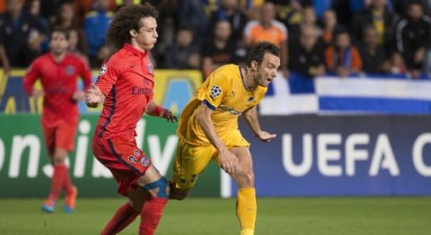 Paris Saint-Germain's defender David Luiz (L) fights for the ball with Apoel FCs striker Gustavo Manduca (R) during his teams UEFA Champions League group F football match against APOEL FC at GSP Stadium in the Cypriot capital Nicosia on October 21, 2014.  AFP PHOTO /JACK GUEZ        (Photo credit should read JACK GUEZ/AFP/Getty Images)