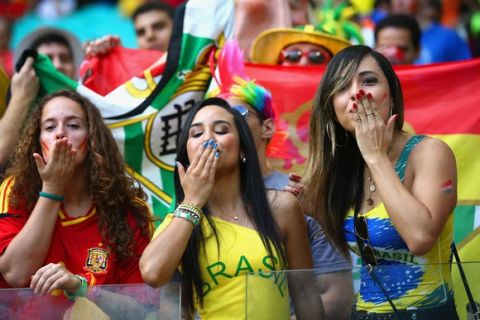 SALVADOR, BRAZIL - JUNE 13: Fans blow kisses before the 2014 FIFA World Cup Brazil Group B match between Spain and Netherlands at Arena Fonte Nova on June 13, 2014 in Salvador, Brazil.  (Photo by Ian Walton/Getty Images)