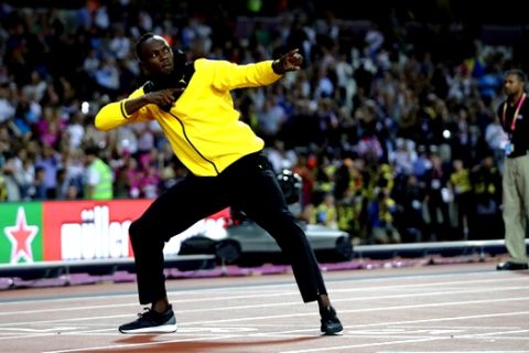 Jamaica's Usain Bolt makes his trademark gesture during a lap of honor at the end of the World Athletics Championships in London Sunday, Aug. 13, 2017. (AP Photo/Matt Dunham)