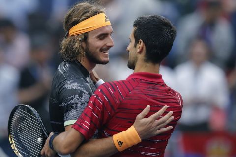 Stefanos Tsitsipas, left, of Greece is congratulated by Novak Djokovic of Serbia after winning in their men's singles quarterfinals match at the Shanghai Masters tennis tournament at Qizhong Forest Sports City Tennis Center in Shanghai, China, Friday, Oct. 11, 2019. (AP Photo/Andy Wong)