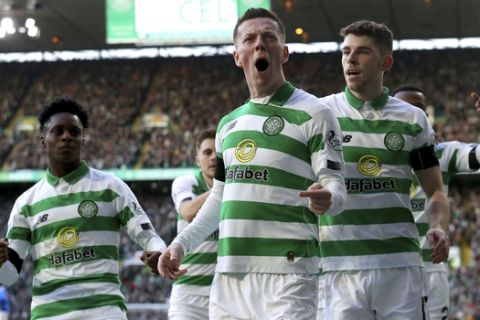 Celtic's Callum McGregor, centre, celebrates after his shot rebounds off team mate Odsonne Edouard who scored their side's first goal of the game, during the Scottish Premiership soccer match between Celtic and Rangers at  Celtic Park, in Glasgow, Scotland, Sunday Dec. 29, 2019. The Scottish title race opened up further when Nikola Katic's header gave Rangers a 2-1 victory over leader Celtic in the derby between the Glasgow rivals.  (Andrew Milligan/PA via AP)