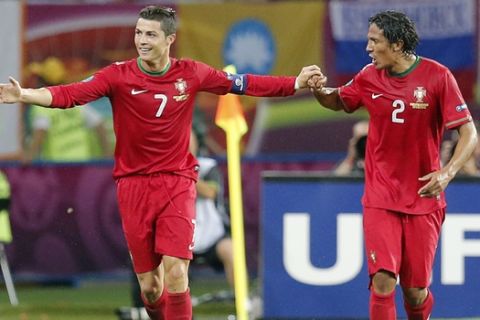 Portugal's Cristiano Ronaldo, left, and Bruno Alves celebrate their second goal during the Euro 2012 soccer championship Group B match between Portugal and the Netherlands in Kharkiv, Ukraine, Sunday, June 17, 2012. (AP Photo/Matthias Schrader) 