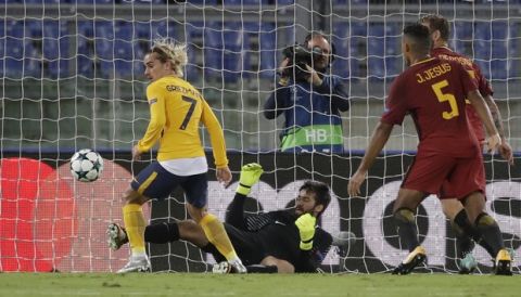 Roma goalkeeper Alisson saves as Atletico's Antoine Griezmann looks at the ball during a Champions League, Group C match, between Roma and Atletico Madrid, at the Olympic stadium in Rome, Tuesday, Sept. 12, 2017. (AP Photo/Alessandra Tarantino)