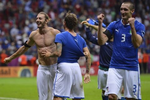 Italian defender Federico  Balzaretti (L) and Italian defender Giorgio Chiellini (R) celebrate their victory at the end of the Euro 2012 football championships semi-final match Germany vs Italy on June 28, 2012 at the National Stadium in Warsaw. Italy won 2-0.     AFP PHOTO/ FABRICE COFFRINI        (Photo credit should read FABRICE COFFRINI/AFP/GettyImages)