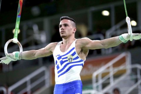Greece's Eleftherios Petrounias performs on the rings during the artistic gymnastics men's qualification at the 2016 Summer Olympics in Rio de Janeiro, Brazil, Saturday, Aug. 6, 2016. (AP Photo/Julio Cortez)