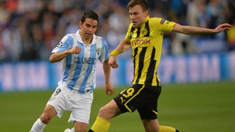 MALAGA, SPAIN - APRIL 03:  Kevin Groflkreutz of Dortmund challenges for the ball withJavier Saviola of Malaga during the UEFA Champion League quarter final first leg match between Malaga CF and Borussia Dortmund at La Rosaleda Stadium on April 3, 2013 in Malaga, Spain.  (Photo by Stuart Franklin/Bongarts/Getty Images)