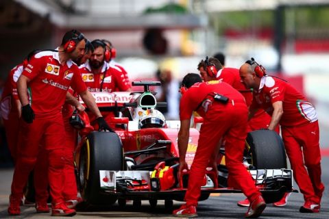 MONTMELO, SPAIN - MAY 17:  Sebastian Vettel of Germany and Ferrari is pushed back into the garage by his team during day one of Formula One testing at Circuit de Catalunya on May 17, 2016 in Montmelo, Spain.  (Photo by Dan Istitene/Getty Images)