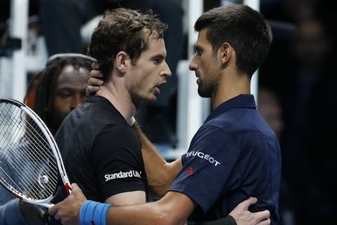 Andy Murray of Britain, left, speaks to Novak Djokovic of Serbia after winning the ATP World Tour Finals singles final tennis match at the O2 Arena in London, Sunday, Nov. 20, 2016. (AP Photo/Alastair Grant)