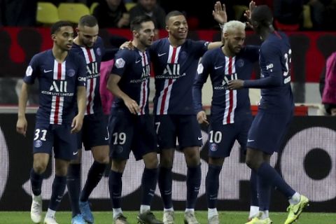 PSG's Kylian Mbappe, center, celebrates with teammates after scoring his side's fourth goal during the French League One soccer match between Monaco and Paris Saint-Germain at the Louis II stadium in Monaco, Wednesday, Jan. 15, 2019. (AP Photo/Daniel Cole)