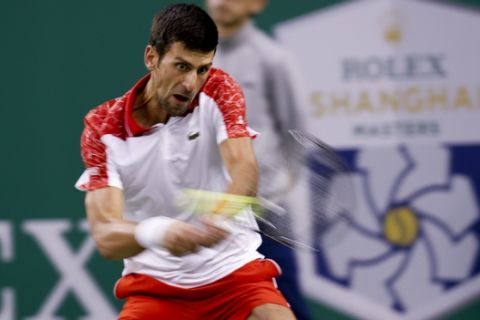 Novak Djokovic of Serbia hits a return shot to Borna Coric of Croatia during their men's singles finals match in the Shanghai Masters tennis tournament at Qizhong Forest Sports City Tennis Center in Shanghai, China, Sunday, Oct. 14, 2018. (AP Photo/Andy Wong)