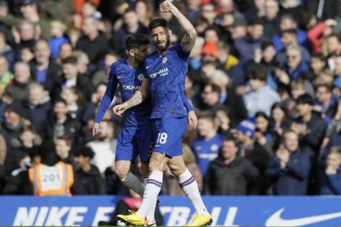Chelsea's Olivier Giroud, right, celebrates after scoring a goal against Tottenham Hotspur's Jan Vertonghen during the English Premier League soccer match between Chelsea and Tottenham Hotspur in London, England, Saturday, Feb. 22, 2020. (AP Photo/Kirsty Wigglesworth)