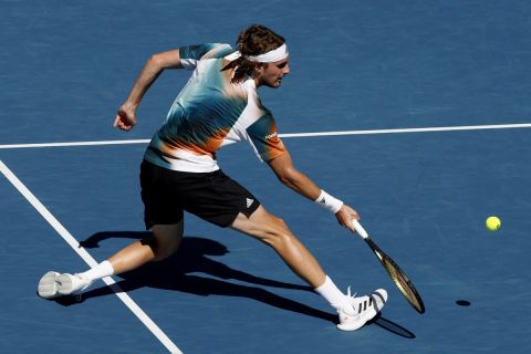 Stefanos Tsitsipas of Greece plays a forehand return to Benoit Paire of France during their third round match at the Australian Open tennis championships in Melbourne, Australia, Saturday, Jan. 22, 2022. (AP Photo/Hamish Blair)