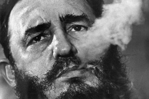 FILE - In this March 1985 file photo, Cuba's leader Fidel Castro exhales cigar smoke during an interview at the presidential palace in Havana, Cuba. Castro has died at age 90. President Raul Castro said on state television that his older brother died late Friday, Nov. 25, 2016. (AP Photo/Charles Tasnadi, File)