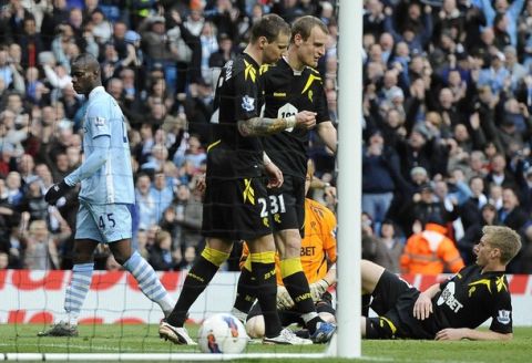 Manchester City's Mario Balotelli (L) reacts after scoring against Bolton Wanderers during their English Premier League soccer match in Manchester, northern England March 3, 2012. REUTERS/Nigel Roddis (BRITAIN - Tags: SPORT SOCCER) FOR EDITORIAL USE ONLY. NOT FOR SALE FOR MARKETING OR ADVERTISING CAMPAIGNS. NO USE WITH UNAUTHORIZED AUDIO, VIDEO, DATA, FIXTURE LISTS, CLUB/LEAGUE LOGOS OR "LIVE" SERVICES. ONLINE IN-MATCH USE LIMITED TO 45 IMAGES, NO VIDEO EMULATION. NO USE IN BETTING, GAMES OR SINGLE CLUB/LEAGUE/PLAYER PUBLICATIONS