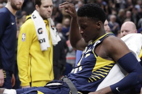 Indiana Pacers guard Victor Oladipo is taken off the court on a stretcher after he was injured during the first half of the team's NBA basketball game against the Toronto Raptors in Indianapolis, Wednesday, Jan. 23, 2019. (AP Photo/Michael Conroy)
