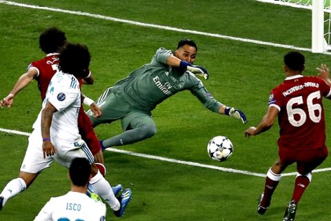 Real Madrid's goalkeeper Keylor Navas, center, saves a shot of Liverpool's Trent Alexander-Arnold, left, during the Champions League Final soccer match between Real Madrid and Liverpool at the Olimpiyskiy Stadium in Kiev, Ukraine, Saturday, May 26, 2018. (AP Photo/Darko Vojinovic)