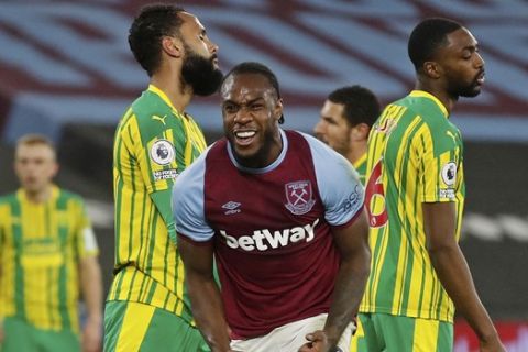 West Ham's Michail Antonio, centre, celebrates after scoring his side's second goal during an English Premier League soccer match between West Ham and West Bromwich Albion at the London Stadium in London, England, Tuesday Jan.19, 2021. (Matthew Childs/Pool via AP)