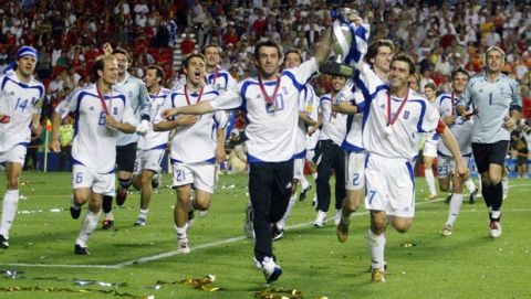 epa000226693 Greek captain Theodoros Zagorakis (front right) and Georgios Karagounis carry the cup in front of their team-mates after the team won the Euro 2004 final between Portugal and Greece at Luz stadium in Lisbon on Sunday, 04 July 2004.  EPA/NUNO VEIGA NO MOBILE PHONE APPLICATIONS