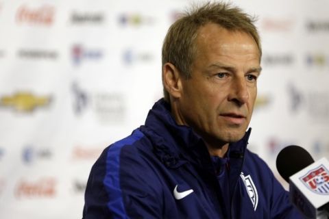 FILE - This Nov. 12, 2015 file photo shows U.S. men's national soccer team coach Jurgen Klinsmann taking part in a news conference in St. Louis. Klinsmann rejects Bob Bradley's claims that he angled to success him as U.S. coach while working as an ESPN analyst during the 2010 World Cup. Bradley made the claim when he was introduced as Swansea, the first American head coach in England's Premier League. (AP Photo/Jeff Roberson, file)