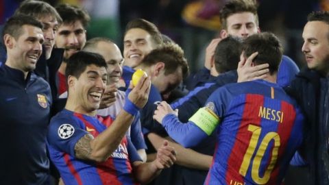 Barcelona's Luis Suarez, left, holds a lemon as he celebrates with his teammate Lionel Messi at the end of the Champions League round of 16, second leg soccer match between FC Barcelona and Paris Saint Germain at the Camp Nou stadium in Barcelona, Spain, Wednesday March 8, 2017. Barcelona won 6-1. (AP Photo/Emilio Morenatti)