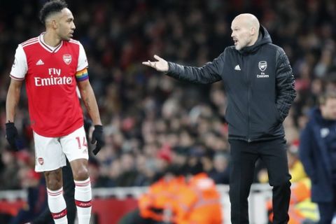 Arsenal's interim head coach Freddie Ljungberg, right, talks to Arsenal's Pierre-Emerick Aubameyang during their English Premier League soccer match between Arsenal and Brighton, at the Emirates Stadium in London, Thursday, Dec. 5, 2019. (AP Photo/Frank Augstein)