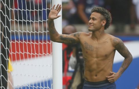 Brazilian soccer star Neymar salutes his fans at the Parc des Princes stadium in Paris, Saturday, Aug. 5, 2017, during his official presentation to fans ahead of Paris Saint-Germain's season opening match against Amiens. Neymar would not play in the club's season opener as the French football league did not receive the player's international transfer certificate before Friday's night deadline. The Brazil star became the most expensive player in soccer history after completing his blockbuster transfer from Barcelona for 222 million euros ($262 million) on Thursday. (AP Photo/Francois Mori)