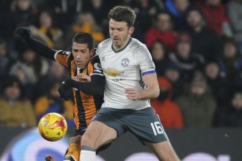 Manchester United's Michael Carrick, right, and Hull's Evandro Goebel battle for the ball during the English League Cup, Semi Final Second Leg soccer match between Hull City and Manchester United at KCOM stadium in Hull, England, Thursday Jan. 26, 2017. (AP Photo/Rui Vieira)
