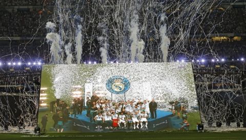 Real Madrid supporters watch on big screens placed at the team's Santiago Bernabeu stadium in Madrid, Spain, for the celebration of their team winning the Champions League final match against Liverpool played in Kiev, Ukraine, Saturday, May 26, 2018. Real Madrid won 3-1. (AP Photo/Francisco Seco)