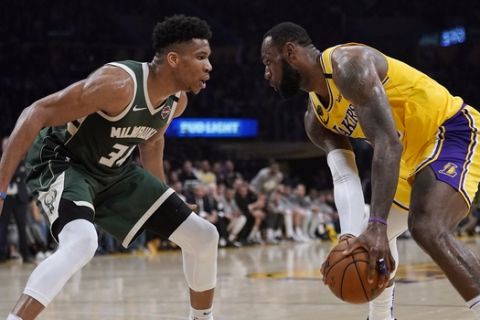 Los Angeles Lakers forward LeBron James, tries to get past Milwaukee Bucks forward Giannis Antetokounmpo during the second half of an NBA basketball game Friday, March 6, 2020, in Los Angeles. (AP Photo/Mark J. Terrill)