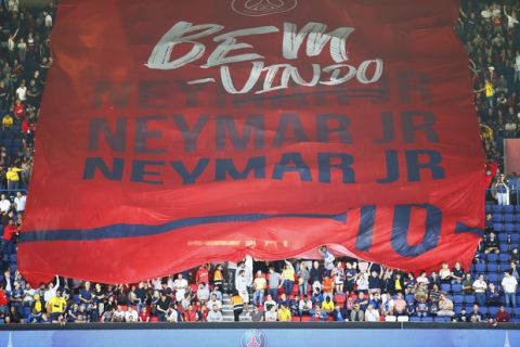 PSG fans welcome Brazilian soccer star Neymar at the Parc des Princes stadium in Paris, Saturday, Aug. 5, 2017, during his official presentation to fans ahead of Paris Saint-Germain's season opening match against Amiens. Neymar would not play in the club's season opener as the French football league did not receive the player's international transfer certificate before Friday's night deadline. The Brazil star became the most expensive player in soccer history after completing his blockbuster transfer from Barcelona for 222 million euros ($262 million) on Thursday. (AP Photo/Francois Mori)