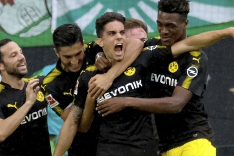 Dortmund's Marc Bartra, third left, celebrates his goal together with Gonzalo Castro. left,  Nuri Sahin, second left,  and Dan-Axel Zagadou, right,  during the German Bundesliga soccer match between VfL Wolfsburg and Borussia Dortmund in  Wolfsburg, Germany, Saturday, Aug. 19,  2017. (Peter Steffen/dpa via AP)