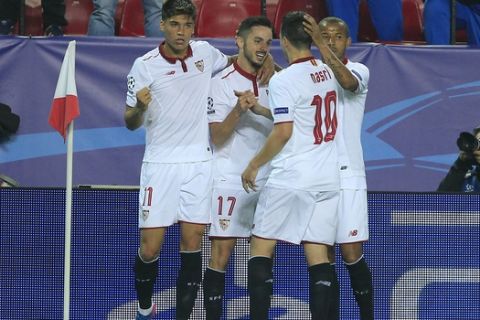 Sevilla players celebrate the goal of Sevilla's Pablo Sarabia, second left, during the Champions League round of 16 soccer match between Sevilla and Leicester City at the Ramon Sanchez-Pizjuan stadium in Seville, Spain, Wednesday, Feb. 22, 2017. (AP Photo/Miguel Morenatti)