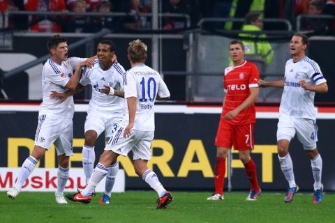 DUESSELDORF, GERMANY - SEPTEMBER 28: Joel Matip of Schalke (2nd L) celebrates the second goal with Klaas-Jan Huntelaar (L) and Lewis Holtby (3rd L) during the Bundesliga match between Fortuna Duesseldorf and FC Schalke 04 at Esprit-Arena on September 28, 2012 in Duesseldorf, Germany. (Photo by Christof Koepsel/Bongarts/Getty Images)