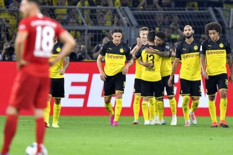 Dortmund's Jadon Sancho celebrates with teammates after scoring his side's second goal during the German Supercup final soccer match between Borussia Dortmund and Bayern Munich in Dortmund, Germany, Saturday, Aug. 3, 2019. (AP Photo/Martin Meissner)