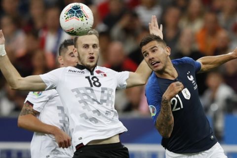France's Lucas Hernandez, right, clears the ball ahead of Albania's Ardian Ismajli during the Euro 2020 group H qualifying soccer match between France and Albania at the Stade de France in Saint Denis, north of Paris, France, Saturday, Sept. 7, 2019. (AP Photo/Christophe Ena)