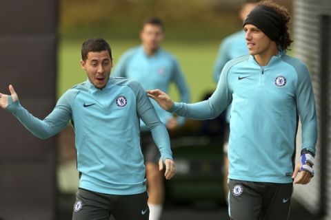 Chelsea's Eden Hazard, left, and David Luiz react at Chelsea's the training  ground, in London Tuesday Oct. 17, 2017.  Chelsea will play against Roma in a  Champions League soccer match in London on Wednesday. (Steven Paston/PA via AP)