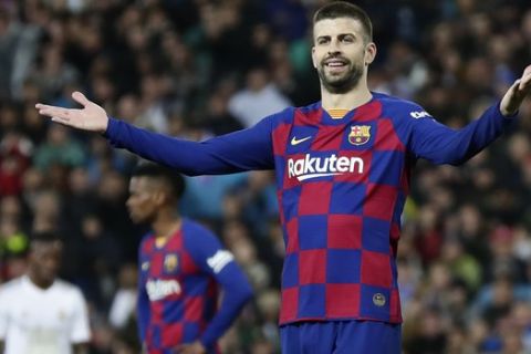 Barcelona's Gerard Pique reacts during the Spanish La Liga soccer match between Real Madrid and Barcelona at the Santiago Bernabeu stadium in Madrid, Spain, Sunday, March 1, 2020. (AP Photo/Manu Fernandez)