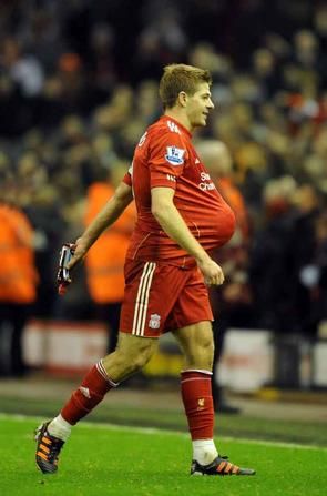 Pic Andrew Teebay. Liverpool FC v Everton FC. Steven Gerrard walks off the field with the ball safely under his shirt at the final whistle after scoring a hatrick against Everton.

